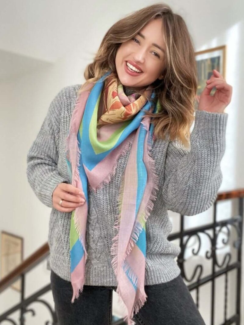 woman wearing Louis Jane French Roses oversized  cashmere and silk square scarf looped around in pink, green and blue colours