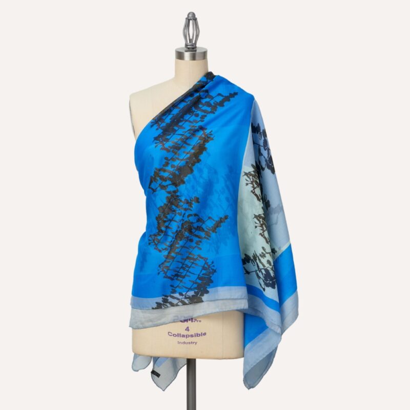 Leaves oversize silk and cotton square shawl, worn over one shoulder, blue colour